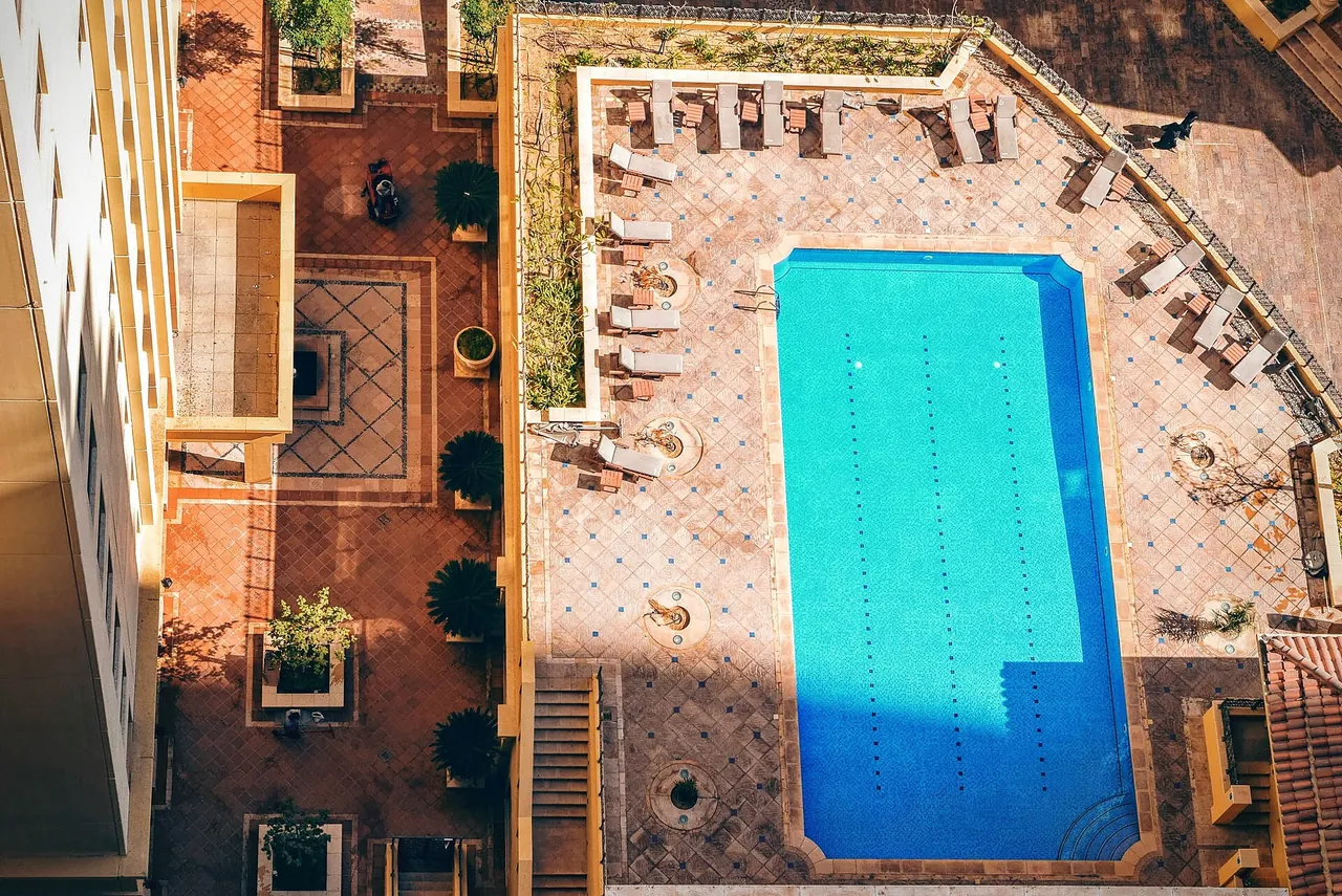 Illustrative photograph of a swimming pool and deck chairs, not a hotel reviewed on this site.